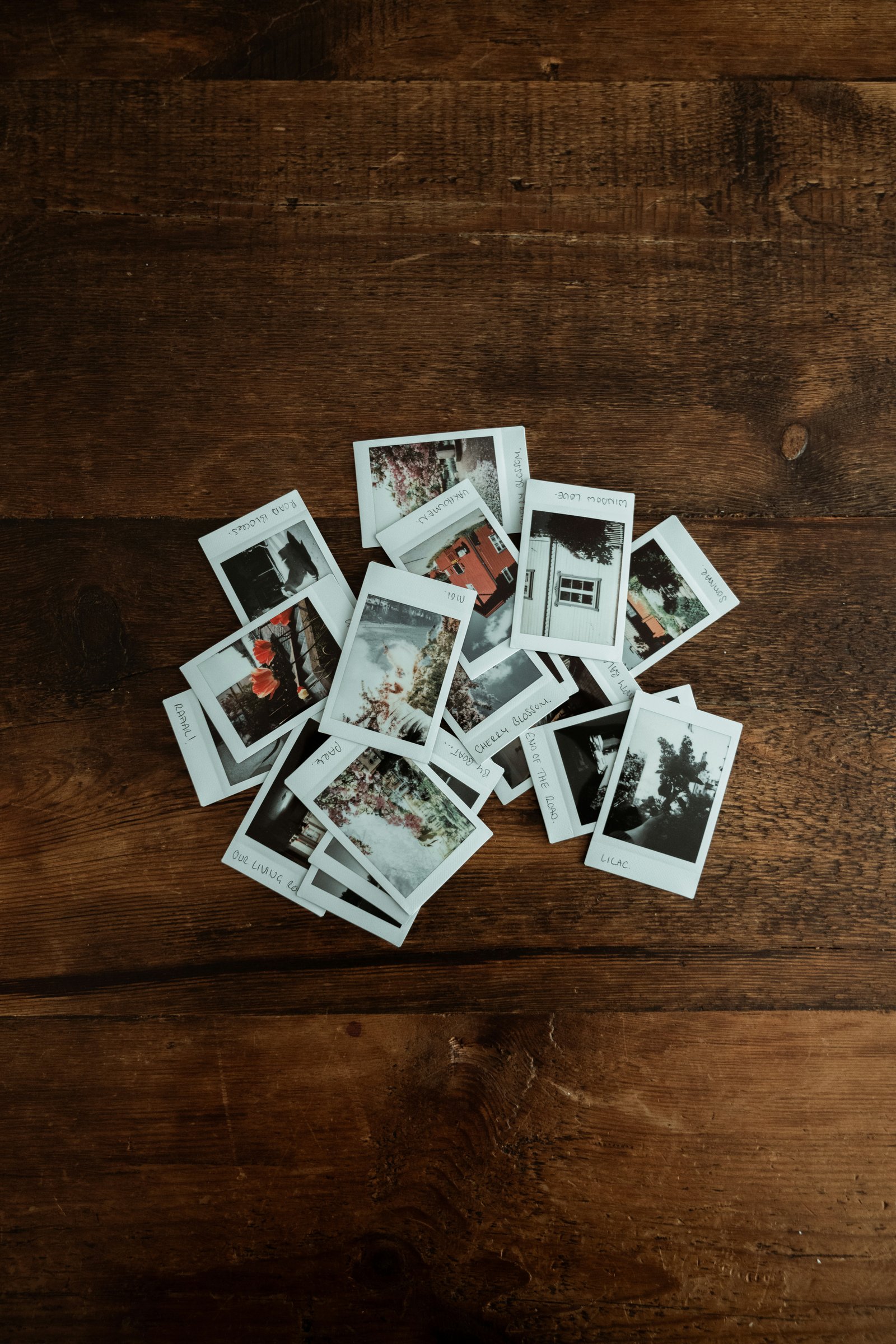 Printed polaroid photos arranged on a wood surface