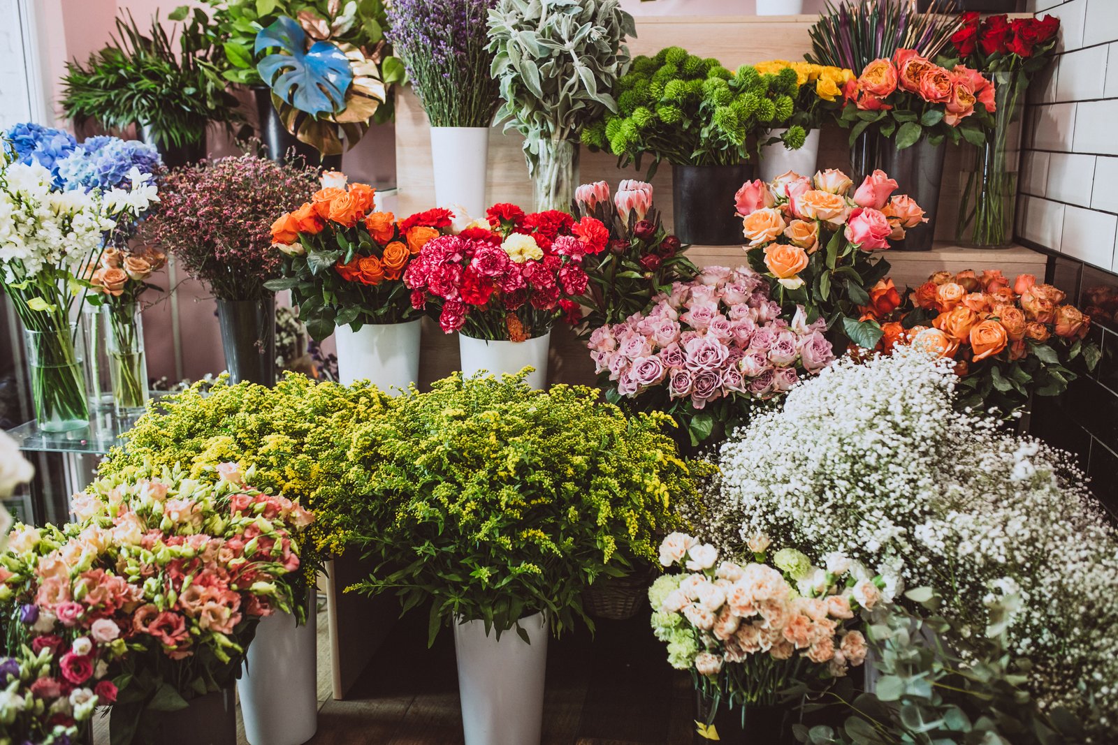Buckets of colorful seasonal flowers at a flower market