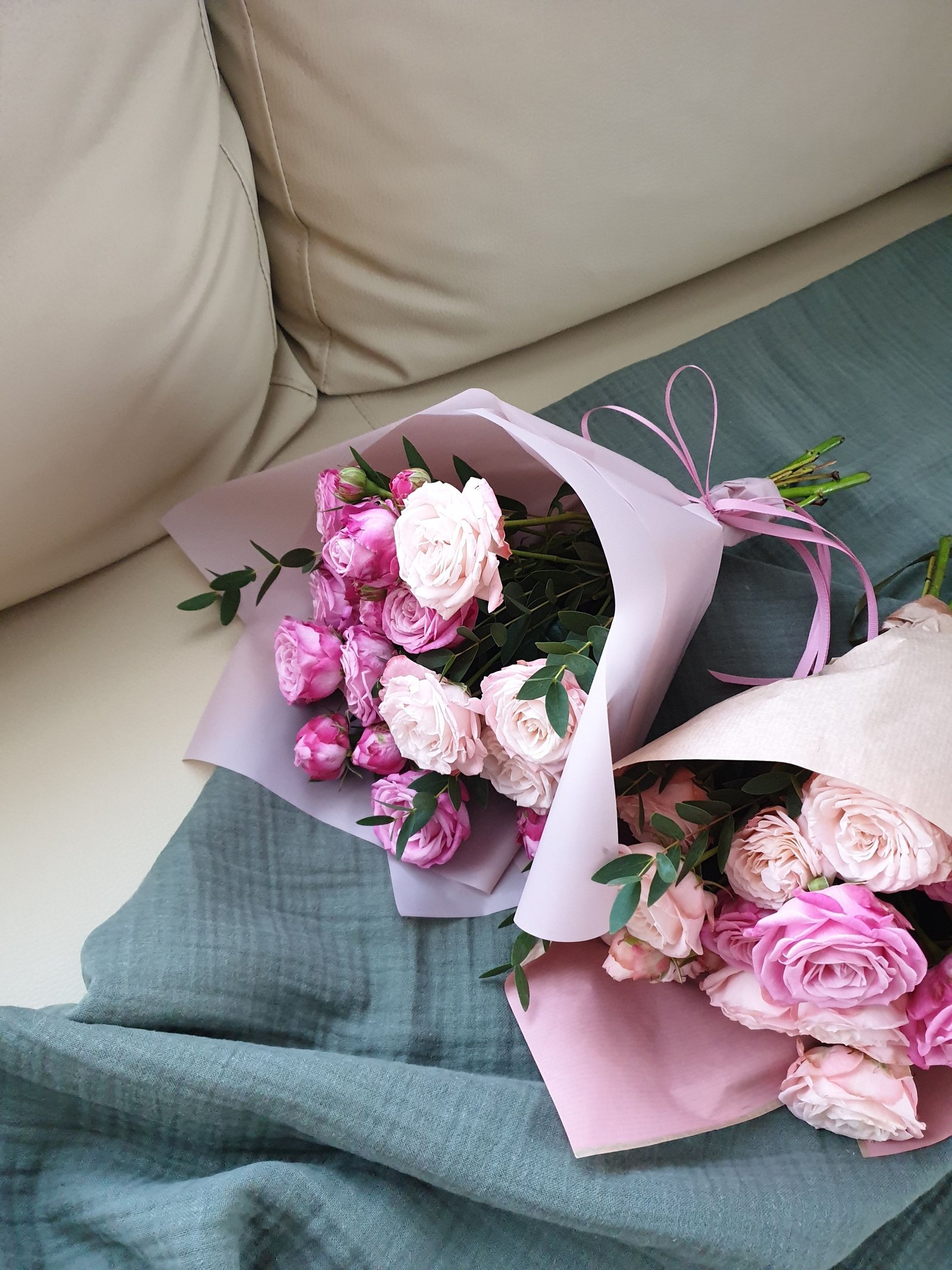 A wrapped bouquet of pink roses